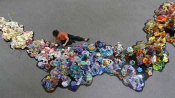 Christine Wertheim installing a crocheted reef exhibit